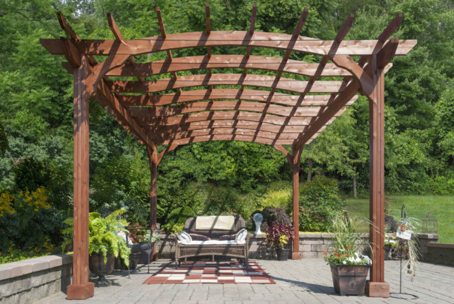 A wooden pergola shading a sitting area.