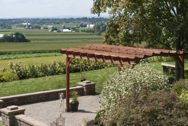 A wooden pergola shading a sitting area.