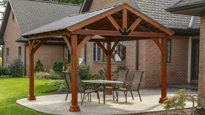 An a frame pavilion sheltering an outdoor seating area.